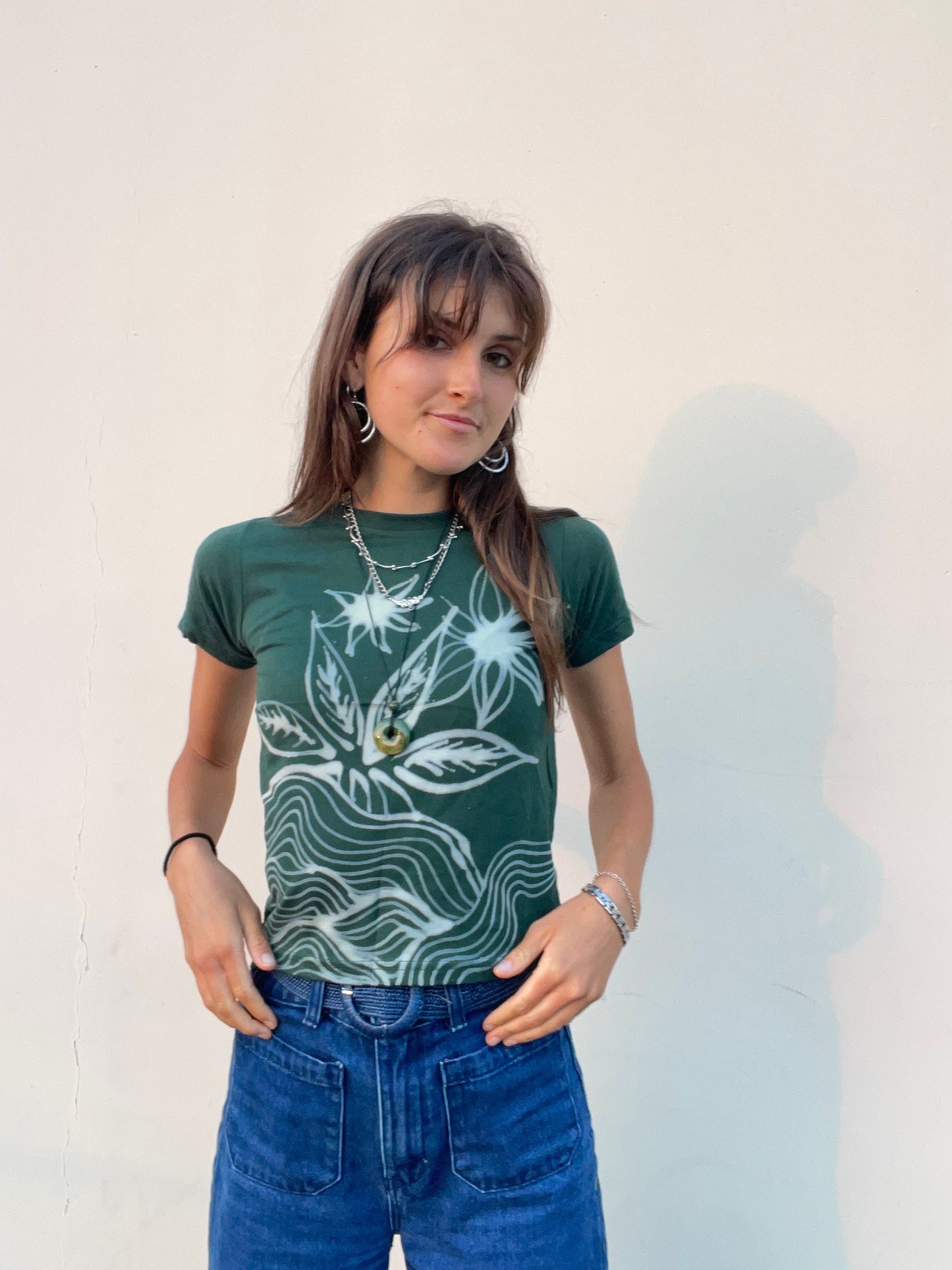 Various handmade flower baby tees