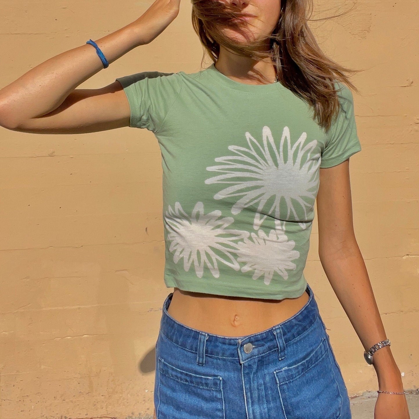 Various handmade flower baby tees