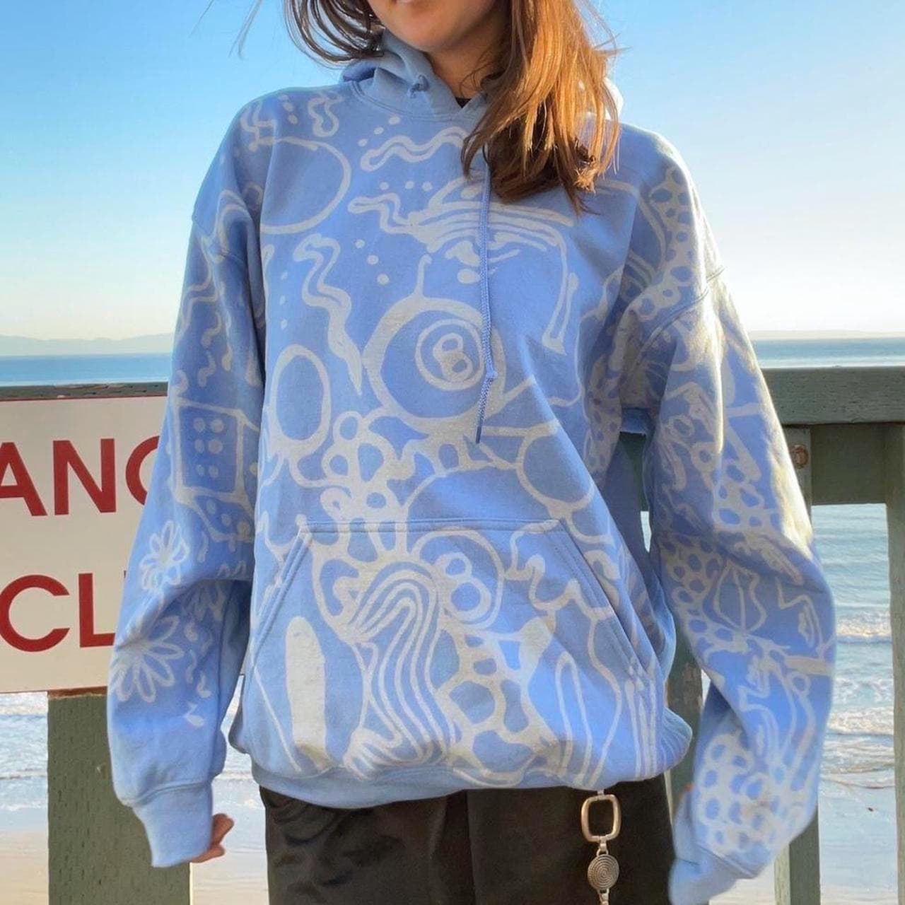 Pastel blue handpainted abstract faces and geometric patterns graphic hoodie