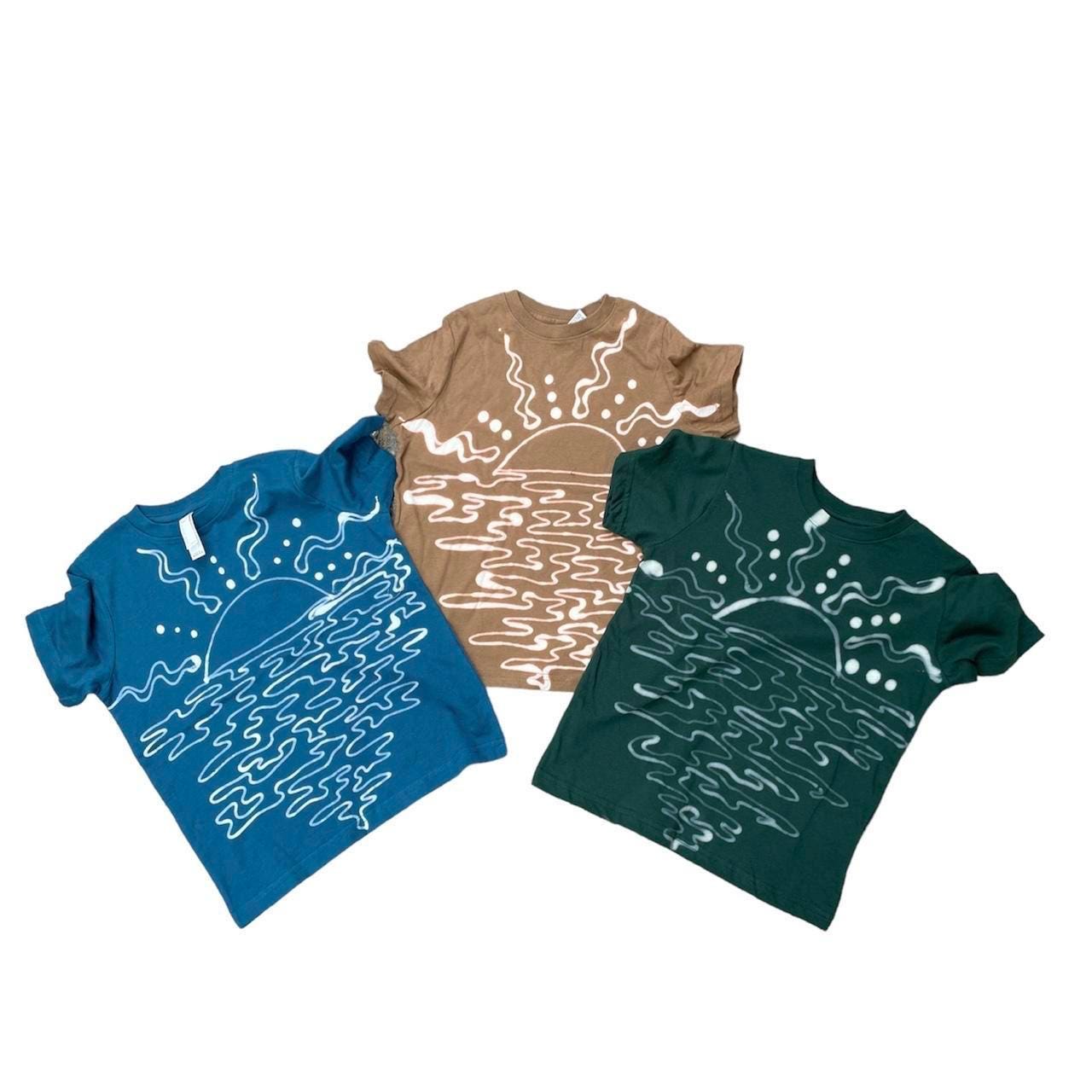 Celestial sun/moon head bodies tee