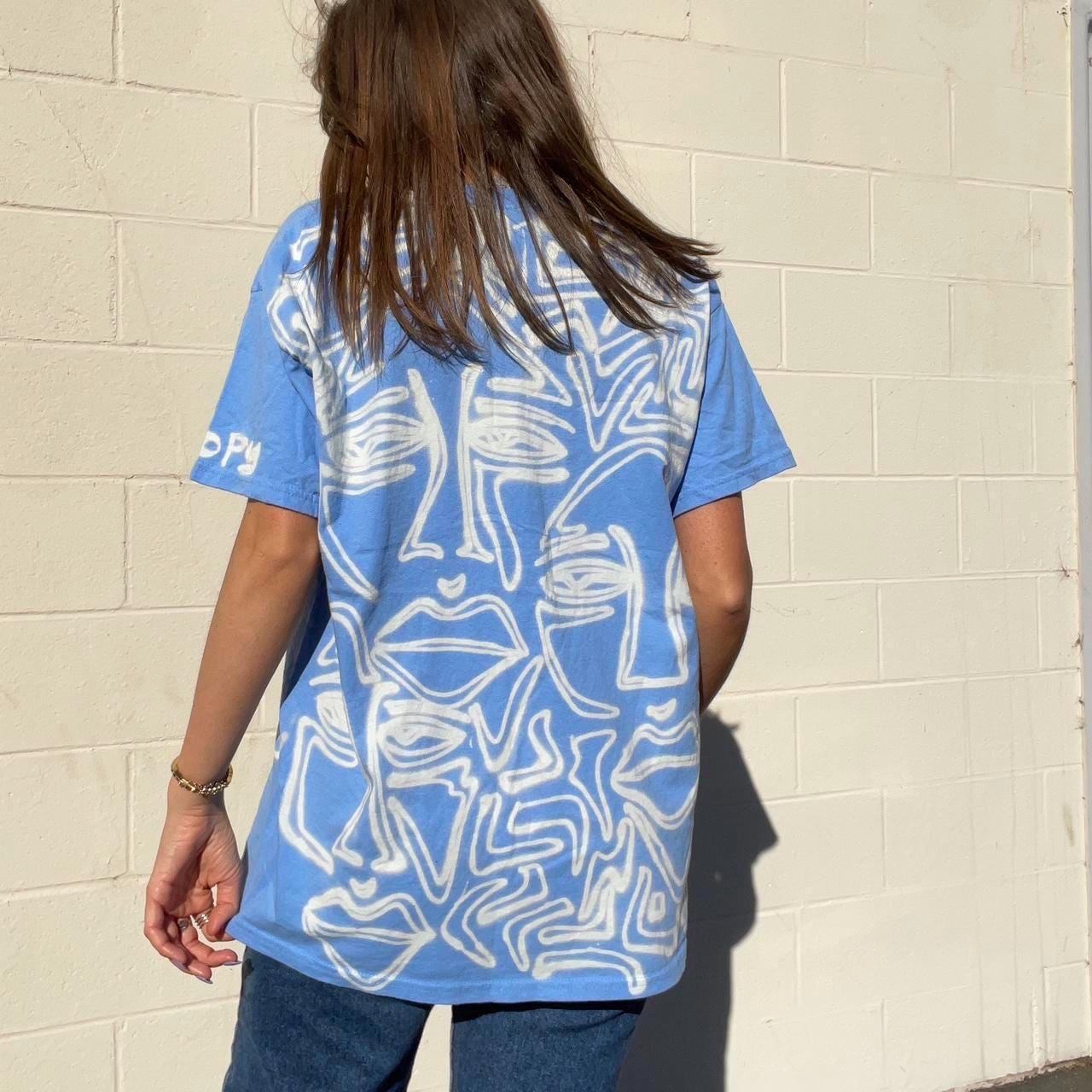 Pastel blue faces graphic oversized tee