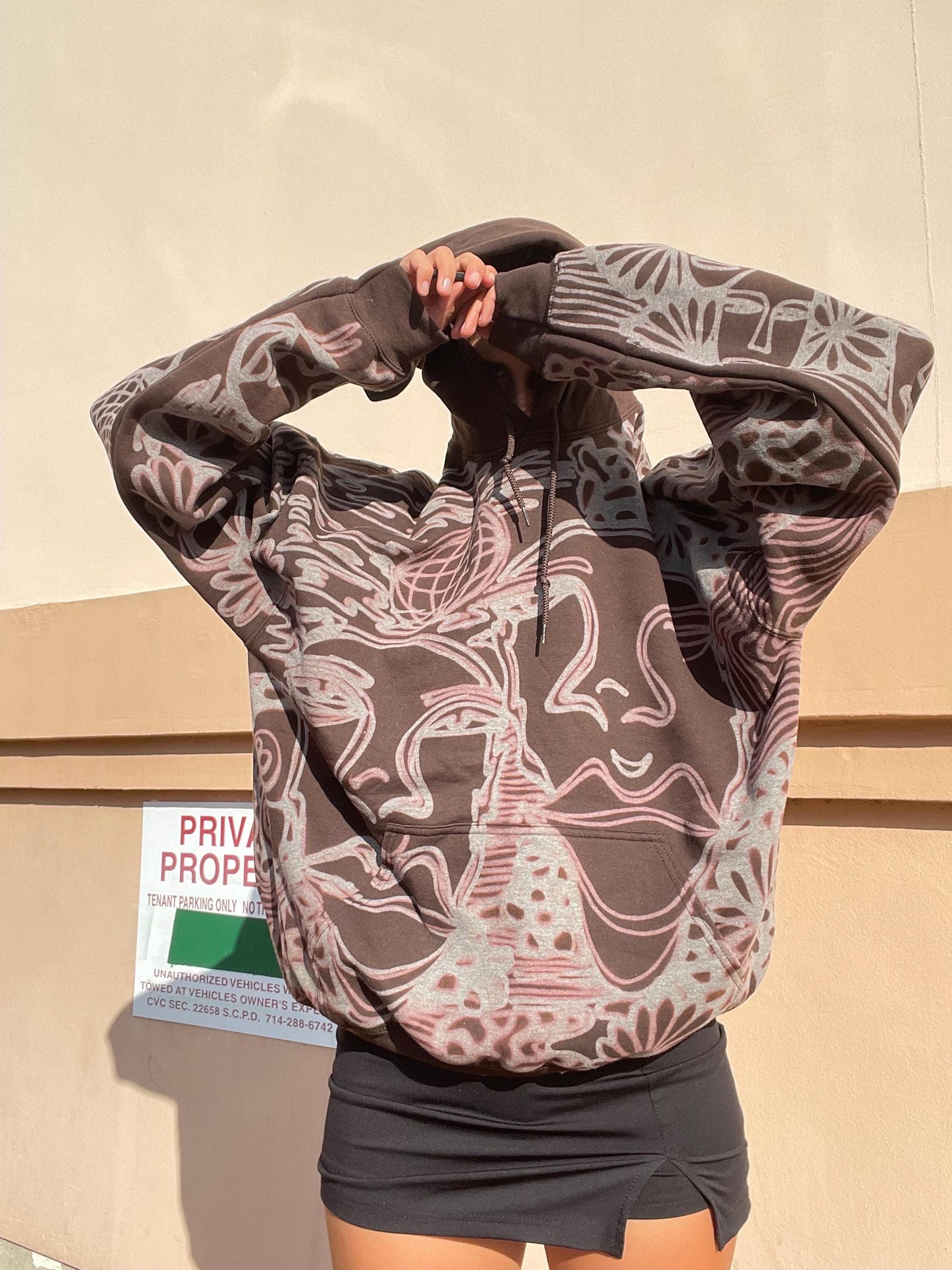 . Abstract faces, spotted mushroom clouds, and geometric cozy hoodie in dark chocolate brown and cream