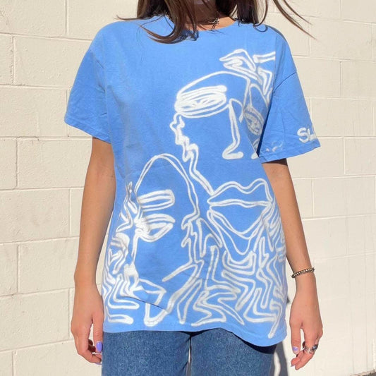 Pastel blue faces graphic oversized tee