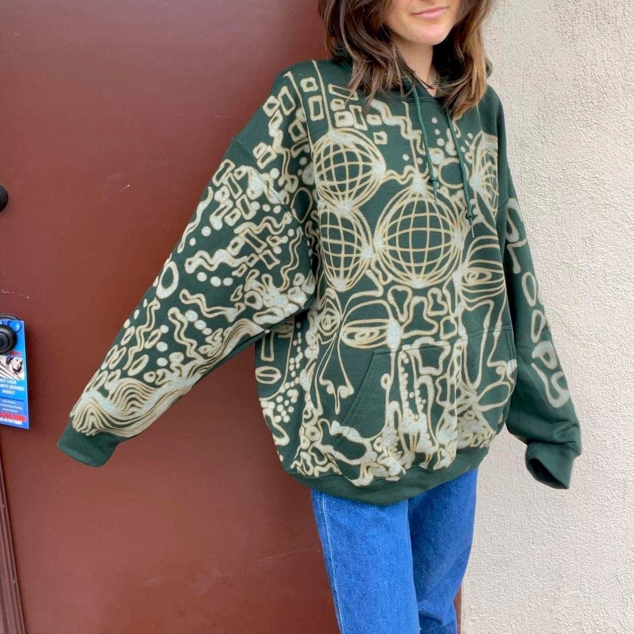 Graphic faces and trippy geometric patterned hoodie
