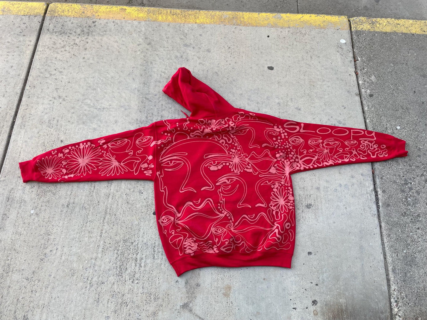 .Abstract faces, floral pattern, and geometric style hoodie in burgandy and cream