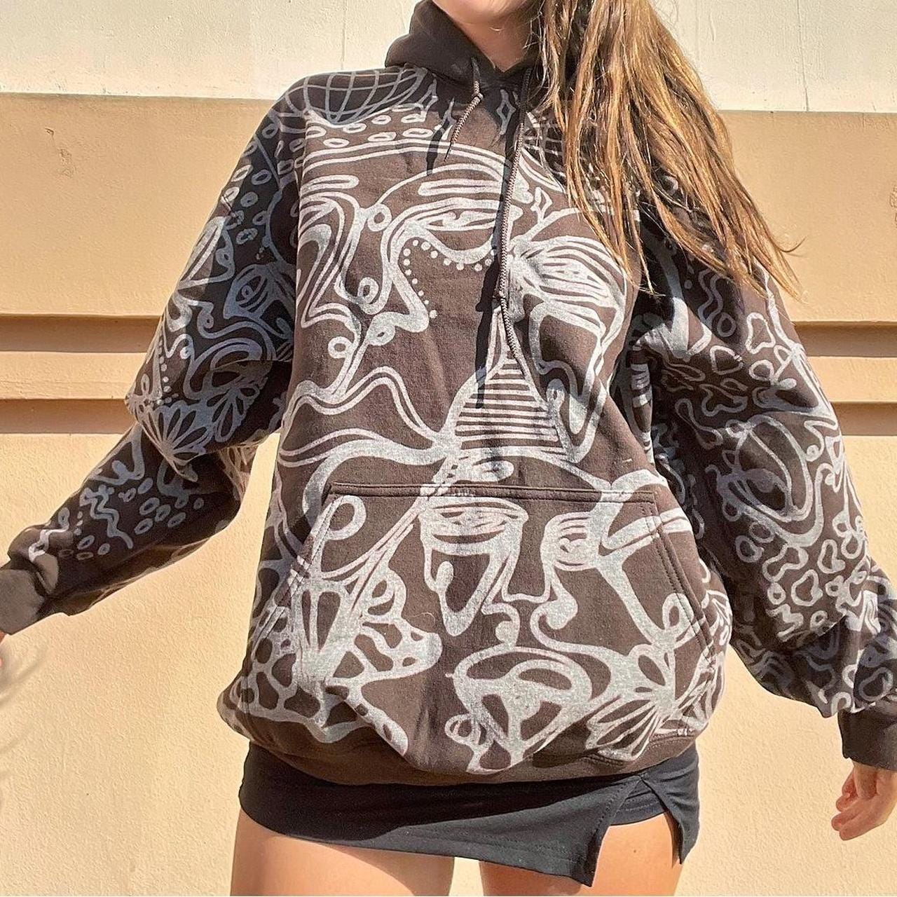 . Abstract faces, spotted mushroom clouds, and geometric cozy hoodie in dark chocolate brown and cream