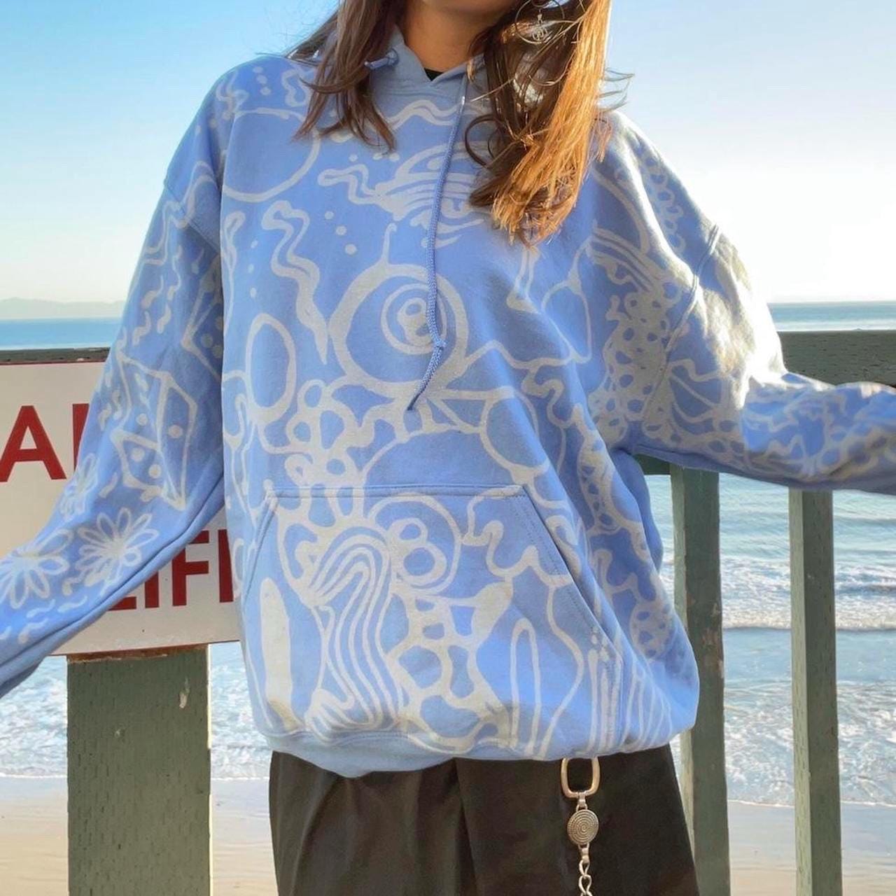 Pastel blue handpainted abstract faces and geometric patterns graphic hoodie