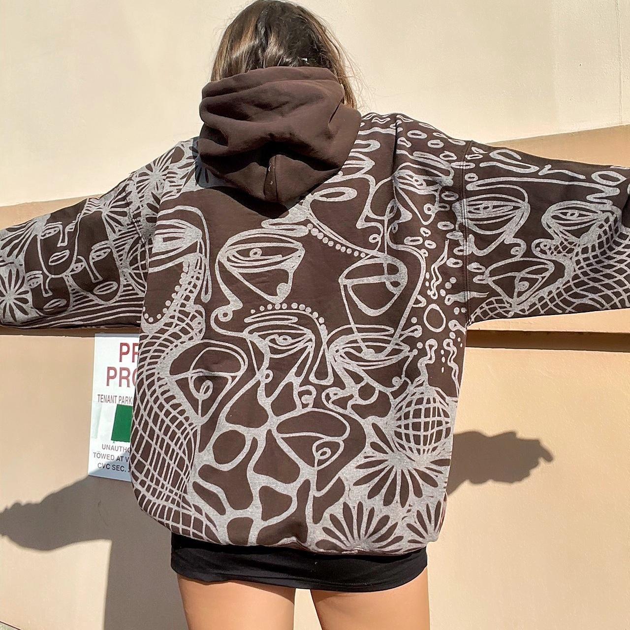 . Abstract faces, spotted mushroom clouds, and geometric cozy hoodie in dark chocolate brown and cream