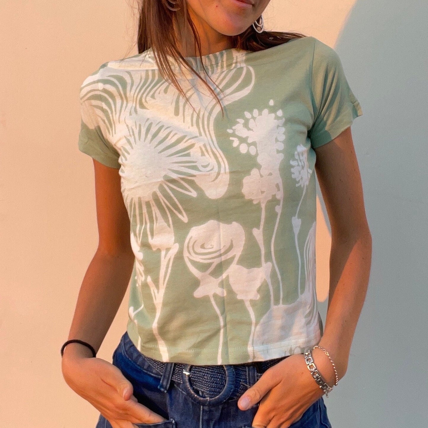 Various handmade flower baby tees