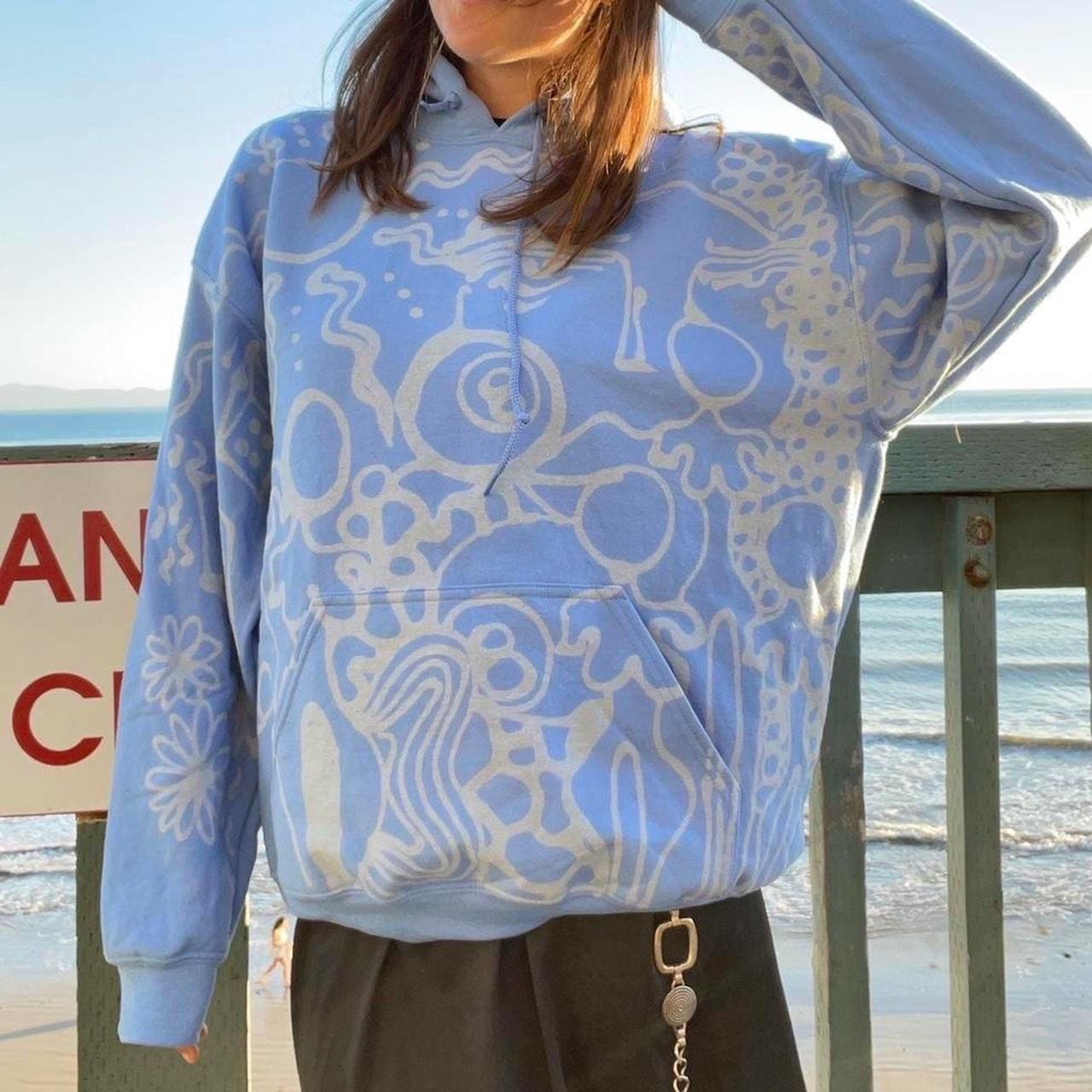 Pastel blue handpainted abstract faces and geometric patterns graphic hoodie