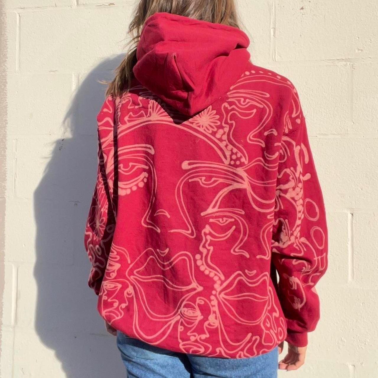 .Abstract faces, floral pattern, and geometric style hoodie in burgandy and cream