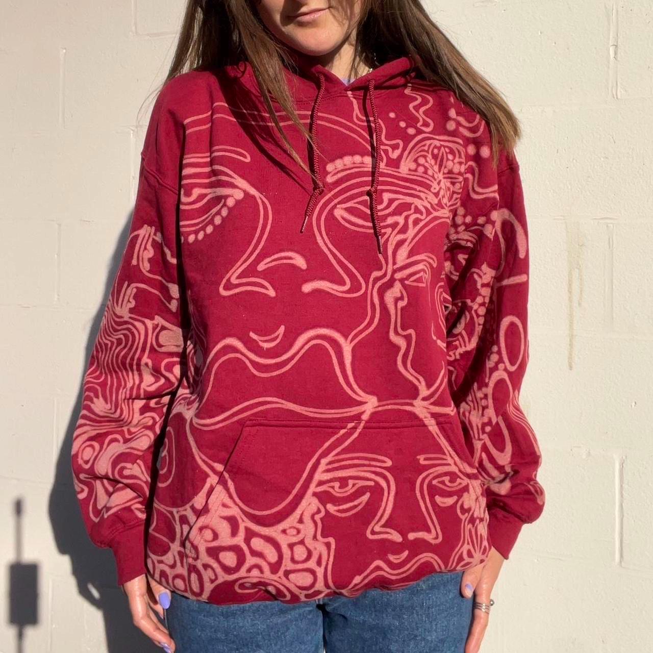 .Abstract faces, floral pattern, and geometric style hoodie in burgandy and cream