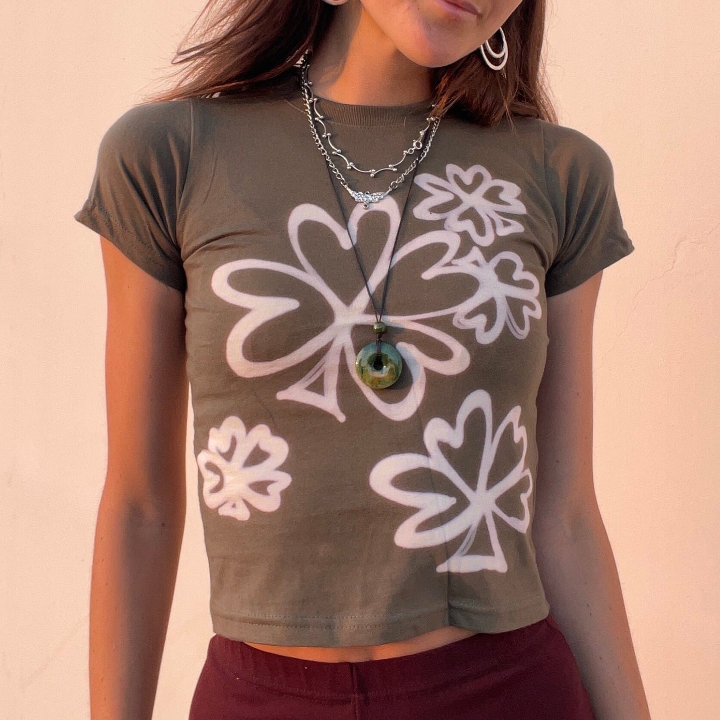 Various handmade flower baby tees